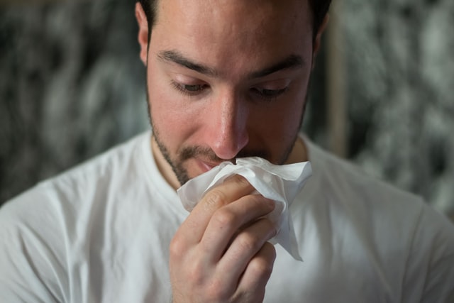 man using cbd and tissue for his allergy