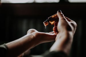 a person putting cbd oil in his hands